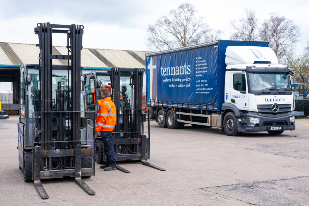two forklifts and truck in the yard